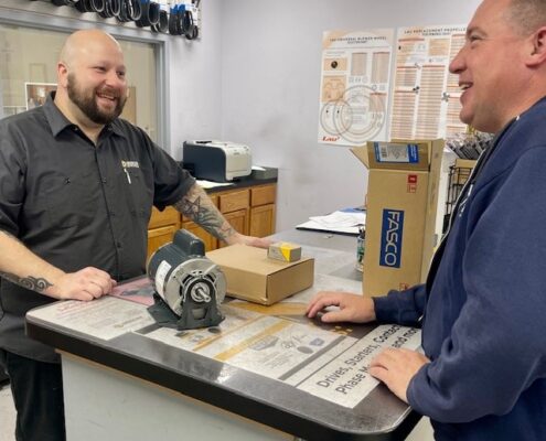 outgrow brian jr with customer electric motor expert helping a customer